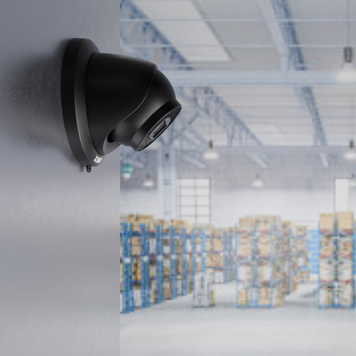 Black Lorex 4MP (2K) A4 IP turret security camera mounted on a warehouse wall, overlooking a large storage area with shelves and boxes—ideal for restaurant supply rooms or food service inventory monitoring.