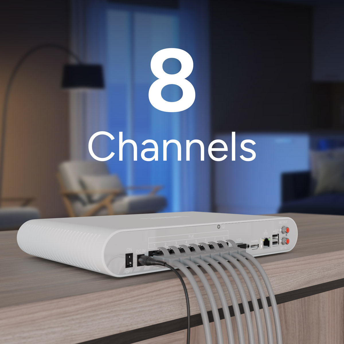 White NVR with multiple ports on a wooden surface, blurred living room background.